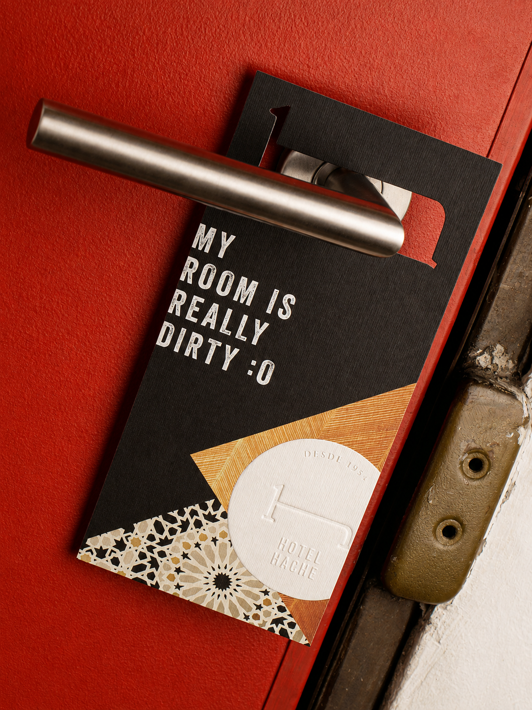 Hotel Hache's red door hanger on a hotel door, the hero piece of the Antalis system.