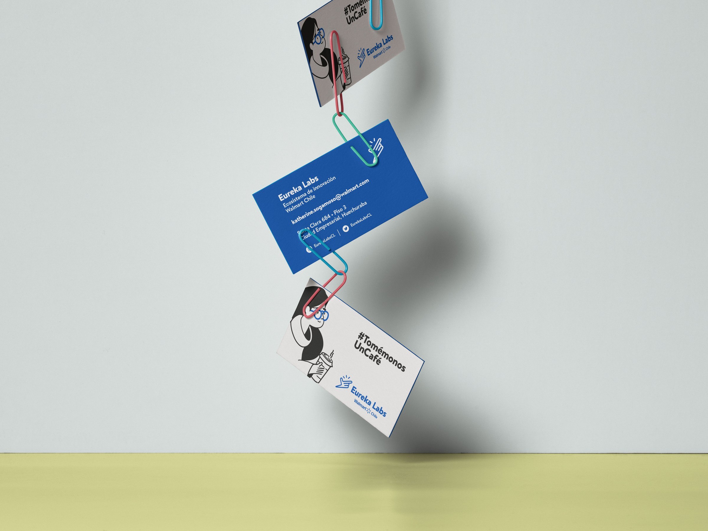 Tarjetas de presentación de Eureka Labs suspendidas con mensajes, ilustraciones y logotipo azul