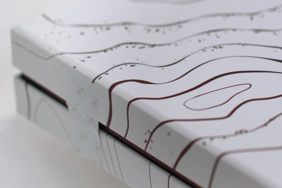 Estuche con relieve de líneas topográficas, detalle de acabado impreso