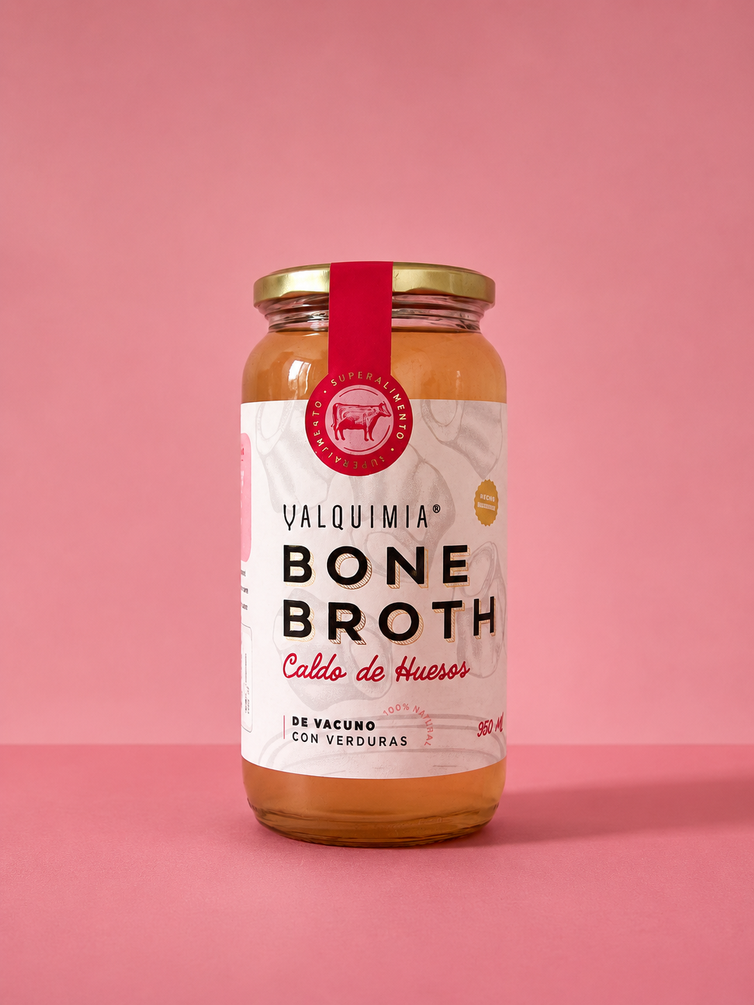 Frasco Valquimia Bone Broth sobre fondo rosado, mostrando el sistema de identidad y packaging desarrollado por JVD.