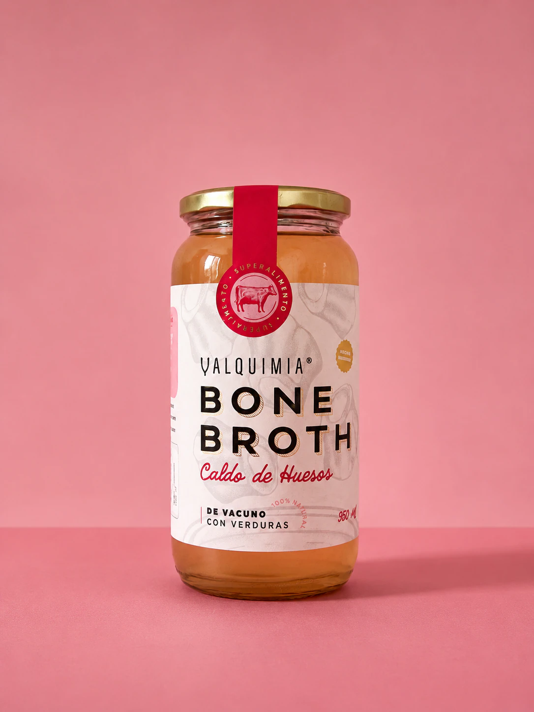 Frasco Valquimia Bone Broth sobre fondo rosado, mostrando el sistema de identidad y packaging desarrollado por JVD.